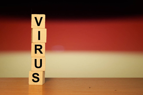 Coronavirus concept background. Germany flag with text VIRUS on wooden cube blocks. - Φωτογραφία, εικόνα