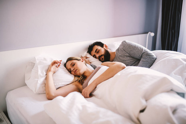 Young couple lying in bed and sleeping. - Photo, Image