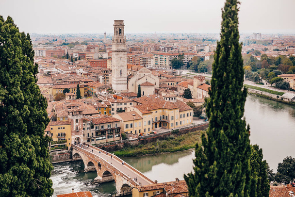View of arched bridge Ponte Pietra over the Adige River in the Italian city of Verona - Φωτογραφία, εικόνα