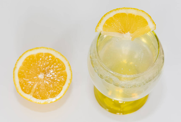 photos of sliced lemon and lemon-flavoured mineral water on a white background - Photo, Image