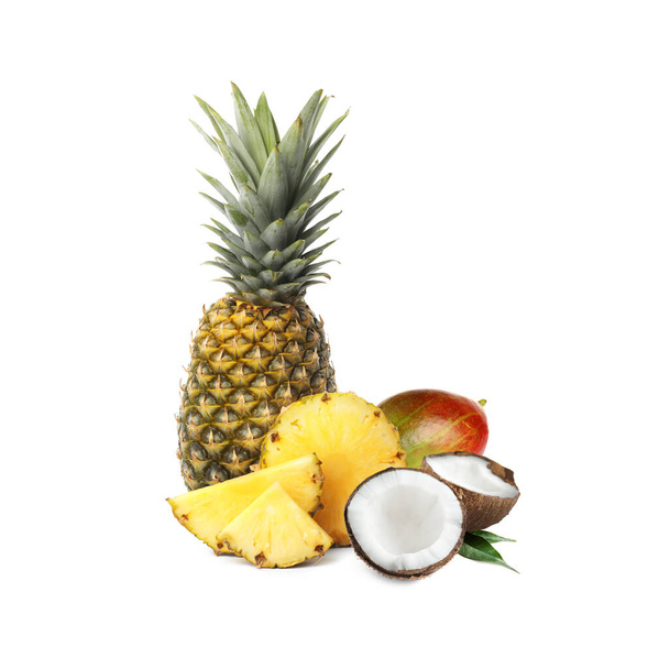 Ripe juicy pineapple, coconut and mango on white background - 写真・画像