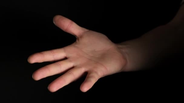 Human male palm clench a fist isolated on black background. Close up. - Séquence, vidéo