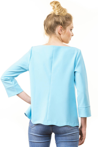 Adult woman presenting her casual beautiful outfit, long sleeved blue top from back. - Photo, Image
