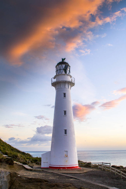 Panoramic scenic landscape view of the Castlepoint lighthouse in sunrise colours, white landmark, tourist popular attraction/destination in North Island, New Zealand.  - Photo, Image