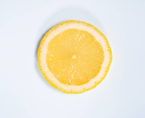 Juicy yellow slice of lemon full of vitamins on a white isolated background - Foto, Bild