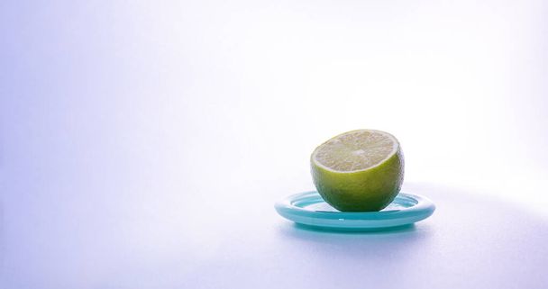 slice of lime on a mint color saucer - Φωτογραφία, εικόνα