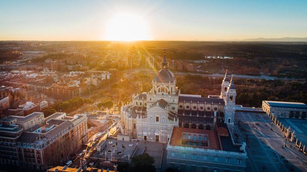 Aerial view of Madrid Cathedral Santa Maria la Real de La Almudena in Madrid, Spain and Royal Palace at sunset. Architecture and landmark of Madrid. Cityscape of Madrid - Fotografie, Obrázek