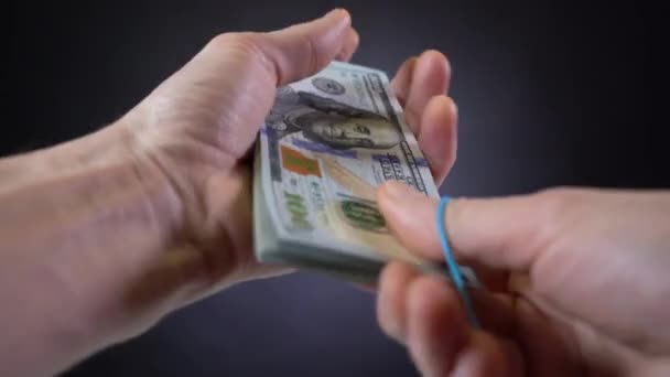A bundle of dollar bills is twisted into a roll - Footage, Video