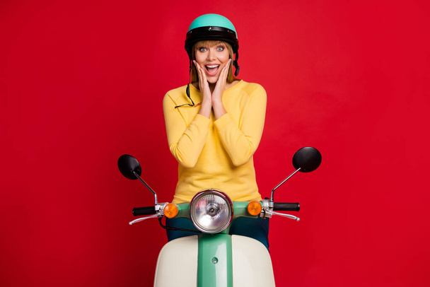 Portrait of amazed crazy funky girl moped rider impressed by incredible wind-like speed scream wow omg wear shine good look jumper isolated over shine color background - Фото, зображення