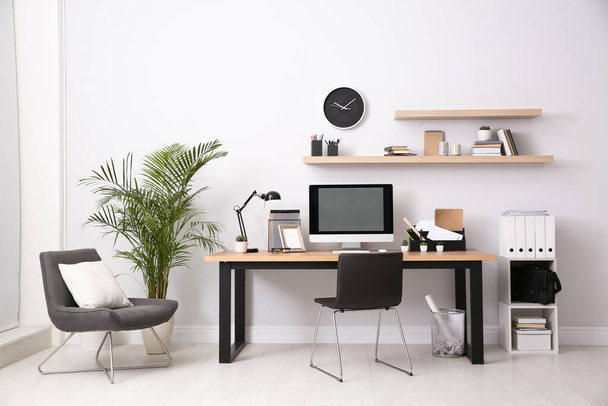 Modern computer on table in office interior. Stylish workplace - Valokuva, kuva