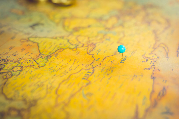 Pin marking on Asia continent on the world map. Selective focused. Vintage tone style. - Photo, Image