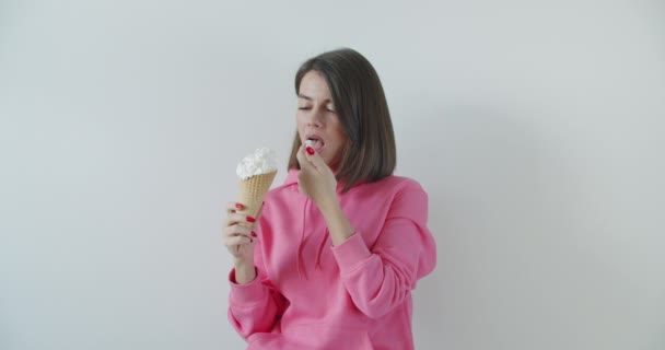 Young woman eating ice cream - Кадри, відео