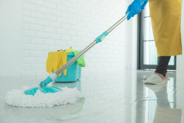 The cleaning staff use mops on the surface and use cleaning agents, which are used to kill germs and viruses. - Foto, Bild