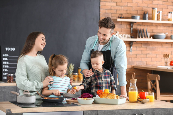Young family cooking together in kitchen - Photo, Image