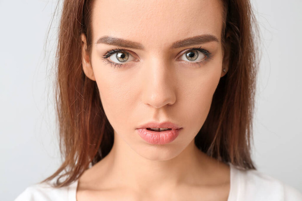 Young woman with beautiful makeup on light background - Fotó, kép