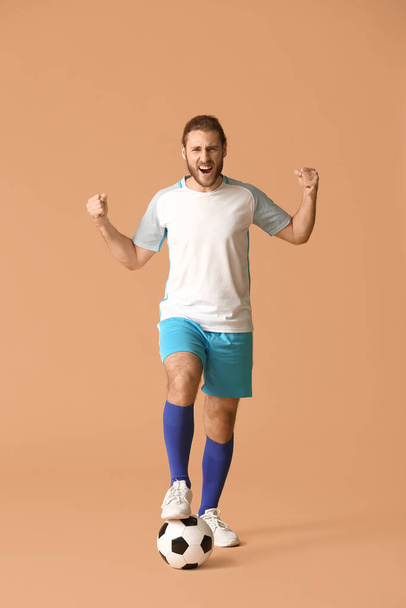 Happy football player on color background - Foto, afbeelding