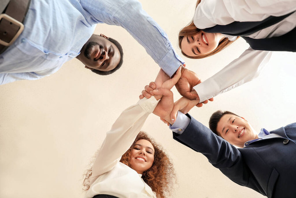 Group of business people holding hands together in office, bottom view. Unity concept - Photo, Image