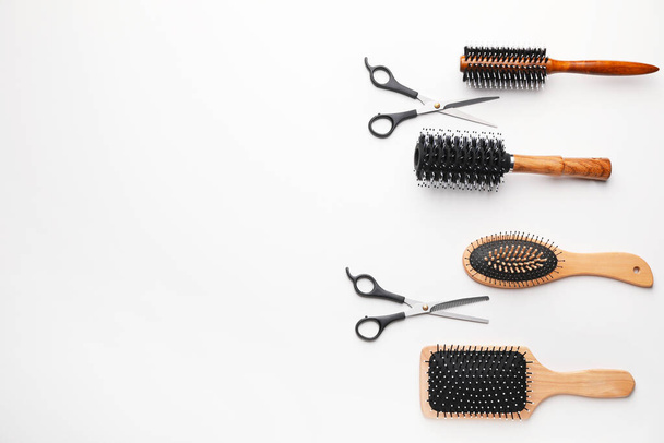 Cepillos para el cabello con tijeras sobre fondo blanco
 - Foto, imagen