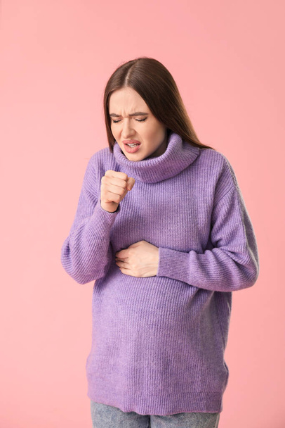 Coughing young pregnant woman on color background - Photo, Image
