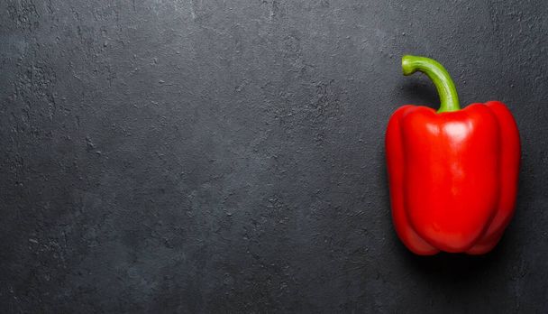 Red pepper on a black background. Paprika. The species capsicum annuum. Copy space. - Foto, imagen