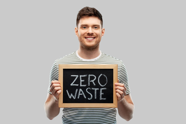 smiling man holding chalkboard with zero waste - Fotó, kép