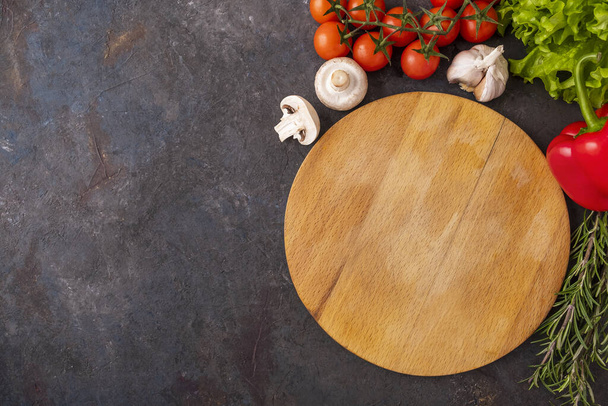 Top view of  empty wooden cutting board and vegetables.  Text space - Photo, Image