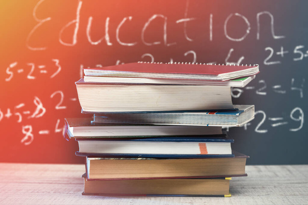 education word on chalkboard with school books on desk, education concept. - Foto, Bild