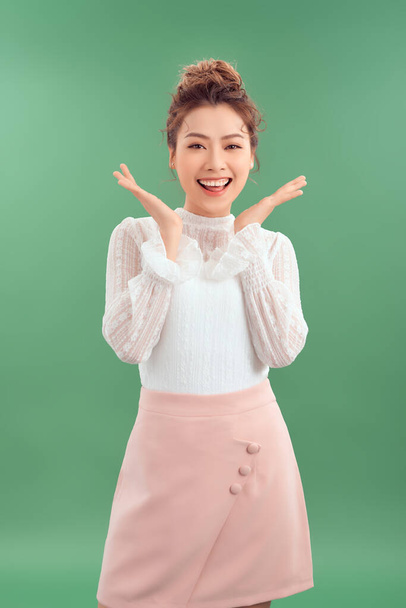 Asian girl is surprised she is excited. Green background studio - 写真・画像