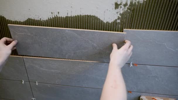 πλακάκια τοποθέτησης πλακιδίων στον τοίχο του μπάνιου - Πλάνα, βίντεο