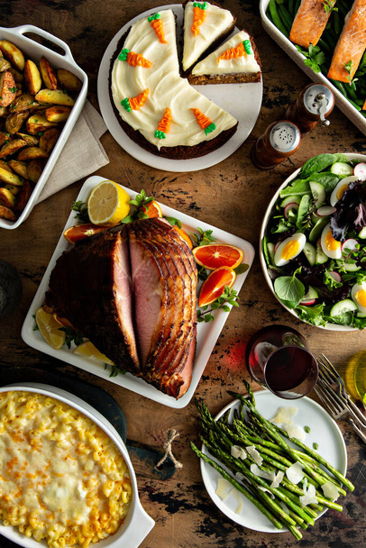 Easter dinner table with ham, asparagus and cake - Фото, зображення