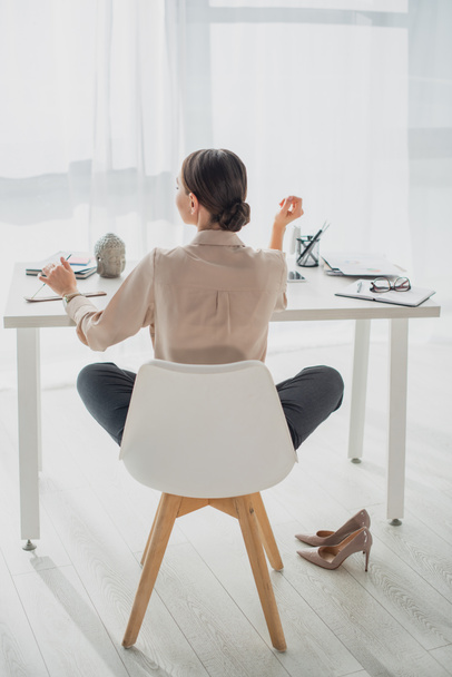 back view of young businesswoman working in modern office - Foto, afbeelding