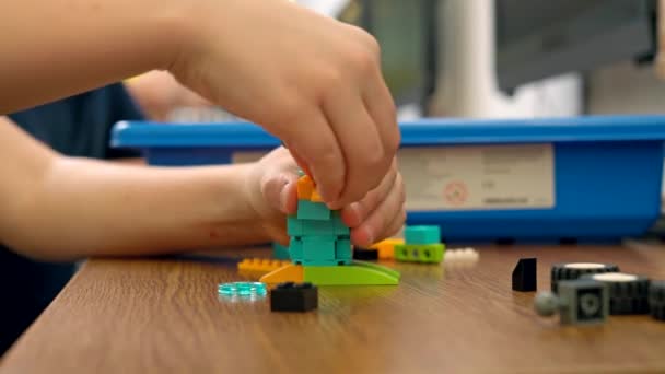 Incognito kid using building kit. - Filmmaterial, Video