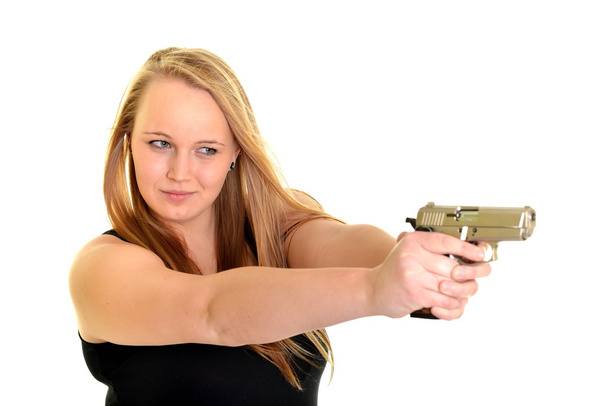 Young beautiful woman holding a gun - Zdjęcie, obraz