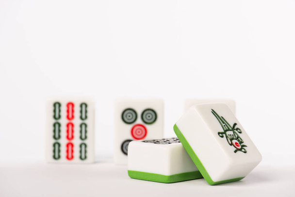 KYIV, UKRAINE - JANUARY 30, 2019: selective focus of mahjong game tiles with signs and characters on white background with copy space - Foto, Imagen