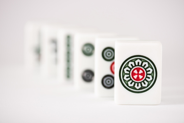 KYIV, UKRAINE - JANUARY 30, 2019: selective focus of mahjong game tiles with signs and characters on white background - 写真・画像
