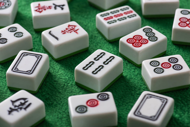 KYIV, UKRAINE - JANUARY 30, 2019: selective focus of white mahjong game tiles with signs and characters on green velour surface - Photo, Image