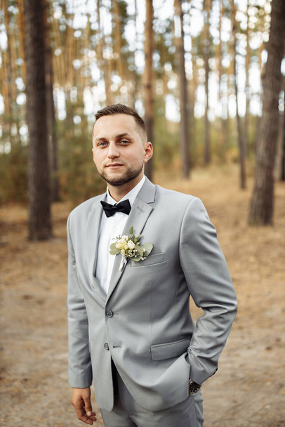 young handsome   man, groom  posing in park - Foto, immagini