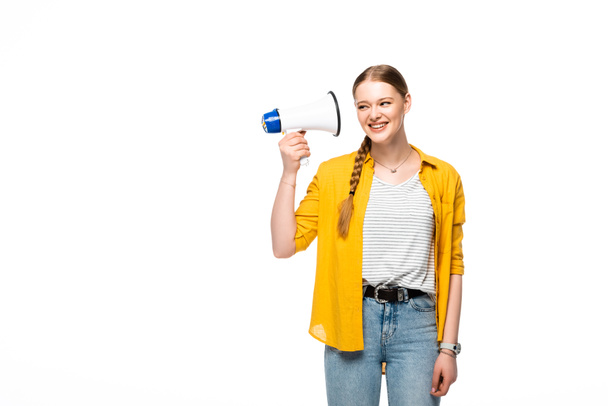 smiling pretty girl with braid holding loudspeaker near ear isolated on white - Фото, изображение