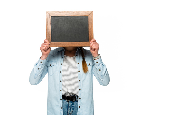 girl with obscure face holding empty chalkboard isolated on white - Foto, Bild