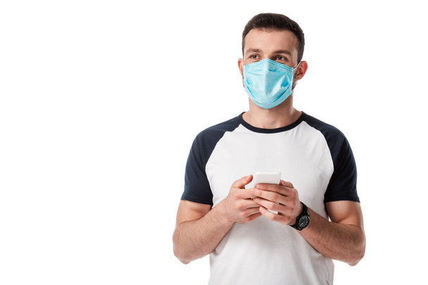man in medical mask holding smartphone isolated on white  - Φωτογραφία, εικόνα