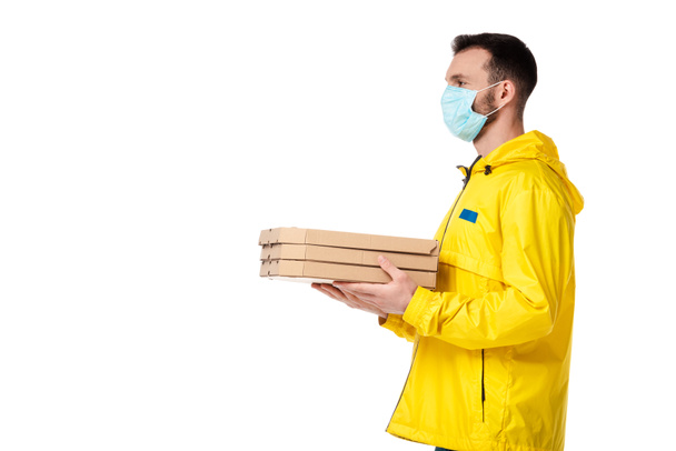 Mavi tıbbi maskeli teslimatçı elinde pizza kutuları tutan beyaz tenli.  - Fotoğraf, Görsel