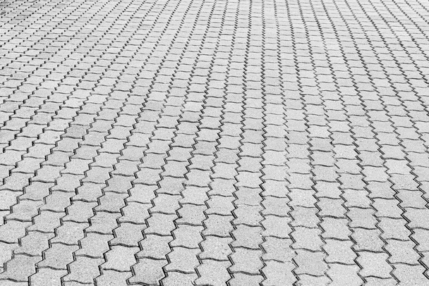 Top view on black and white paving stone road. Old pavement of granite texture. Street cobblestone sidewalk. Abstract background for design. - Photo, Image