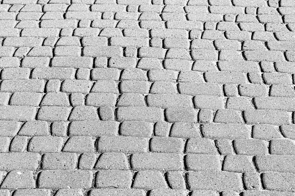 Top view on paving stone road. Old pavement of granite texture. Street cobblestone sidewalk. Abstract background for design. - Photo, Image