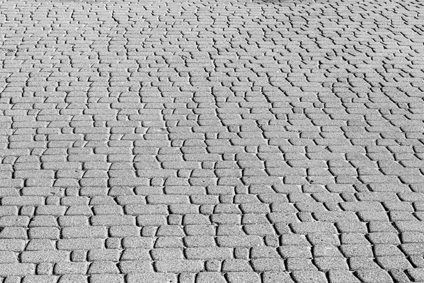 Top view on monochrome paving stone road. Old pavement of granite texture. Street cobblestone sidewalk. Abstract background for design. - Photo, Image