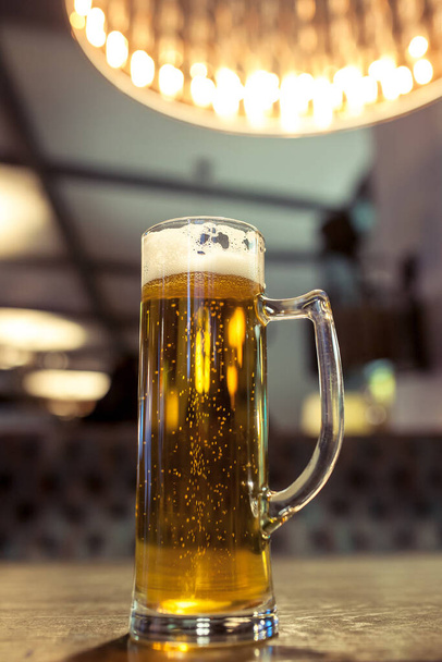 glass of beer on a table in a bar - Φωτογραφία, εικόνα