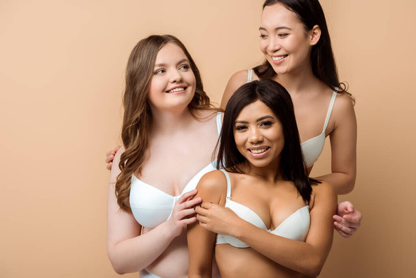 sorridente più dimensioni donne multiculturali in reggiseni isolati su beige
  - Foto, immagini