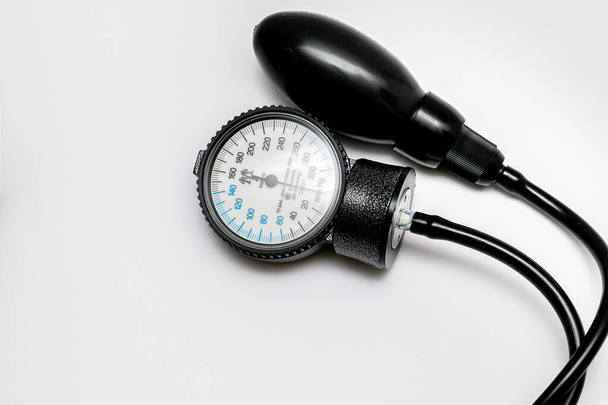 The black tonometer lies on a white background. View from above. Tonograph for measuring pressure. Close-up - Fotó, kép