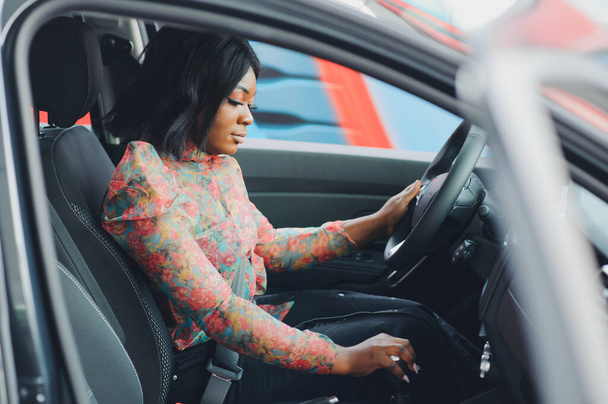 cheerful african female driver inside a car - Valokuva, kuva