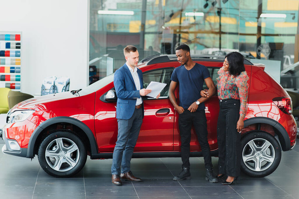 young african couple buying new car at dealership - Photo, Image
