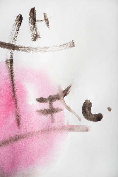 Japanese painting with hieroglyphs painted with grey and pink watercolor on white  - Photo, Image